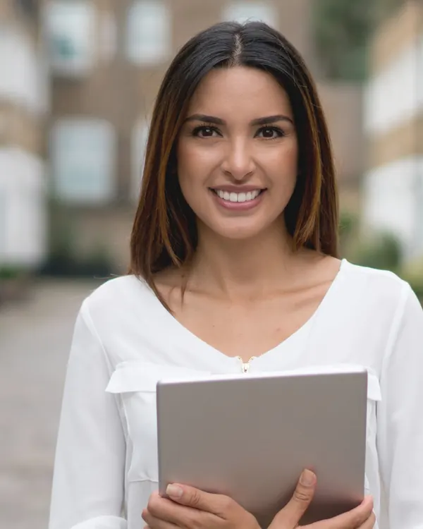 An estate agent outside a row of houses