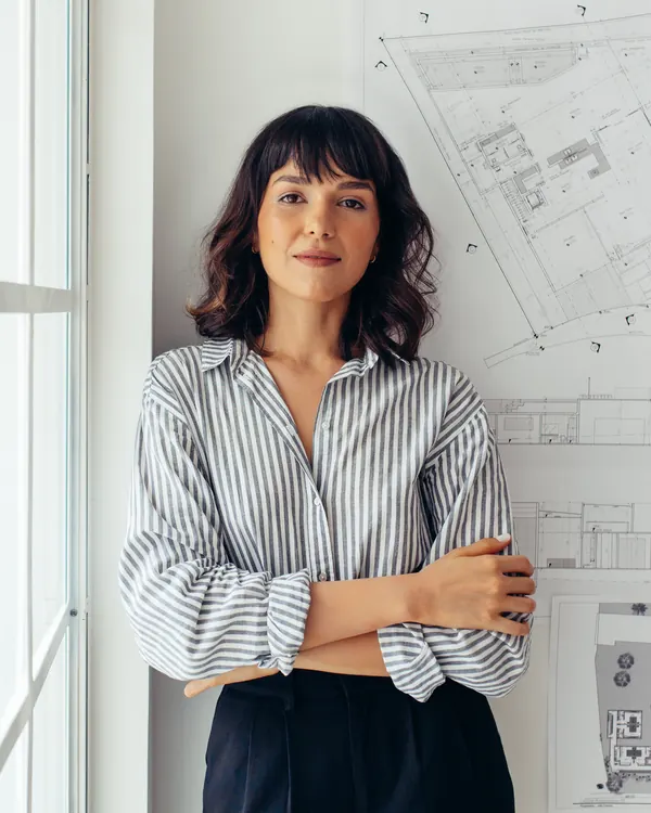 An architect beside building drawings