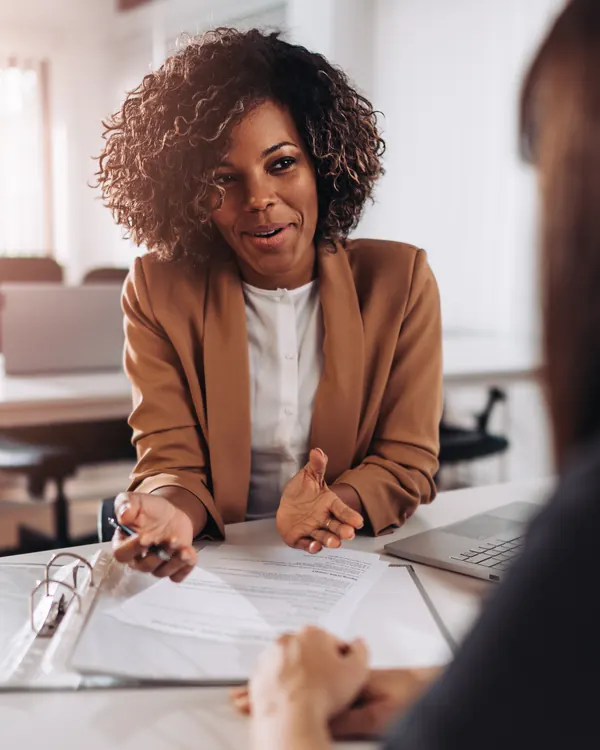 A consultant advising a client at a desk